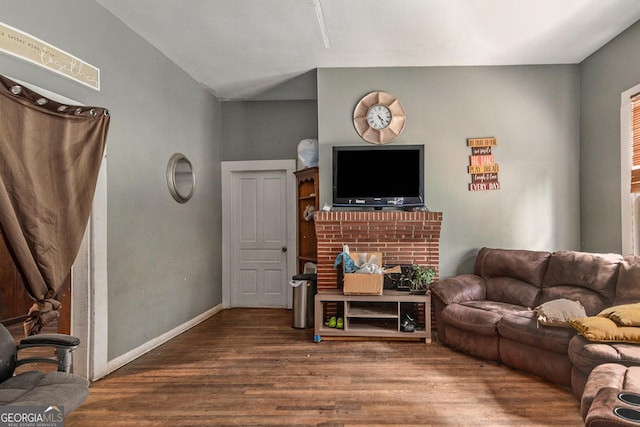 living room with vaulted ceiling and hardwood / wood-style floors