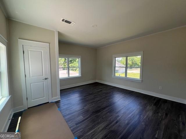 unfurnished room featuring dark hardwood / wood-style floors