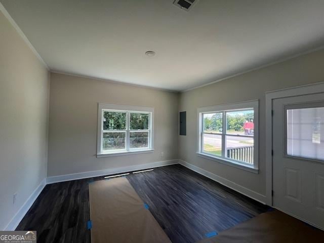 entrance foyer with electric panel, dark wood-type flooring, and ornamental molding