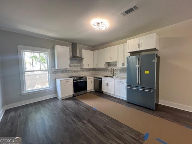 kitchen featuring wall chimney exhaust hood, stainless steel appliances, sink, dark hardwood / wood-style floors, and white cabinetry