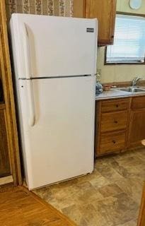 kitchen featuring sink and white fridge