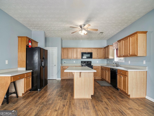 1301 Crosswind Pl, Mcdonough, GA 30252 - kitchen with dark wood-style flooring, light countertops, a ceiling fan, black appliances, and a kitchen island