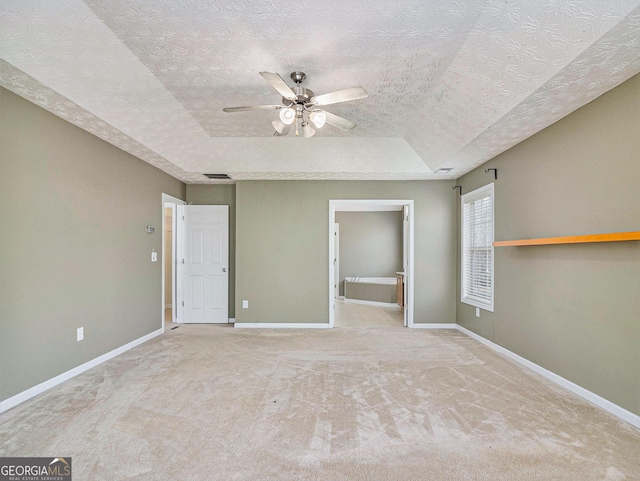 1301 Crosswind Pl, Mcdonough, GA 30252 - unfurnished bedroom with a textured ceiling, visible vents, carpet flooring, a raised ceiling, and baseboards