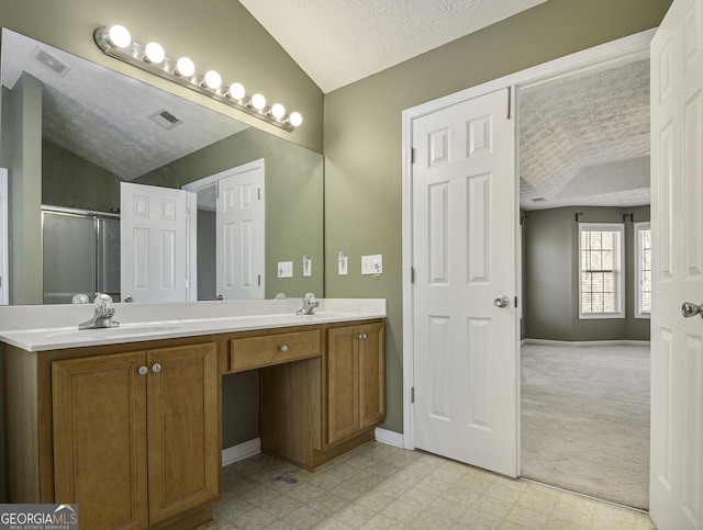 1301 Crosswind Pl, Mcdonough, GA 30252 - bathroom featuring a shower stall, visible vents, a sink, lofted ceiling, and tile patterned floors