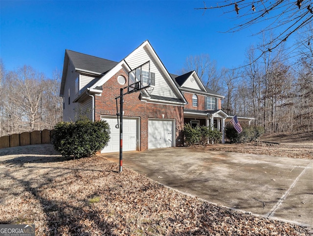 1301 Crosswind Pl, Mcdonough, GA 30252 - view of property exterior featuring concrete driveway, brick siding, fence, and a garage