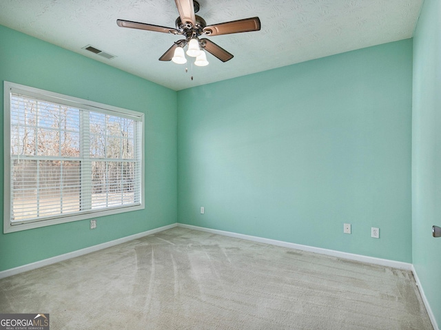 1301 Crosswind Pl, Mcdonough, GA 30252 - unfurnished room with visible vents, a textured ceiling, a ceiling fan, and carpet floors