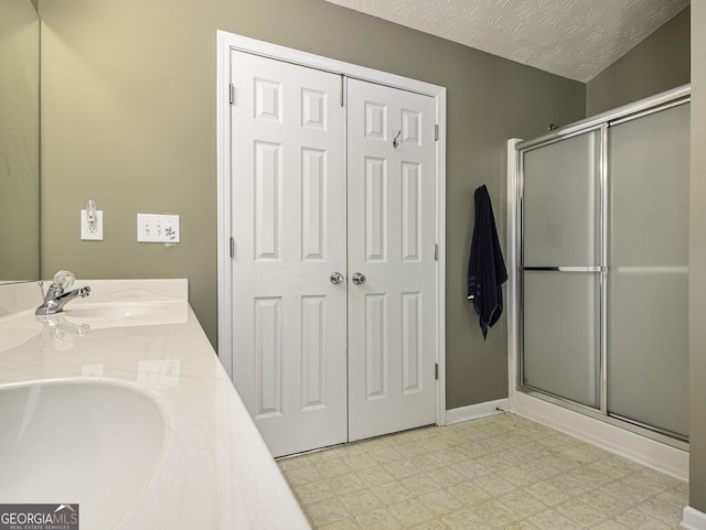 1301 Crosswind Pl, Mcdonough, GA 30252 - full bath featuring a sink, tile patterned floors, a shower stall, and a textured ceiling