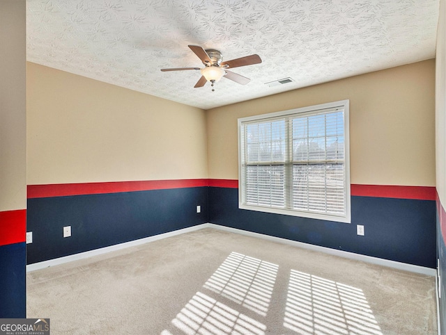 1301 Crosswind Pl, Mcdonough, GA 30252 - carpeted spare room with a textured ceiling, ceiling fan, baseboards, and visible vents
