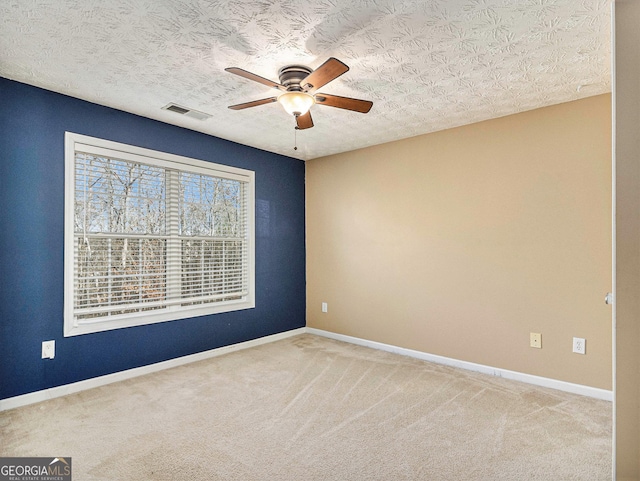 1301 Crosswind Pl, Mcdonough, GA 30252 - carpeted empty room with visible vents, baseboards, a ceiling fan, and a textured ceiling