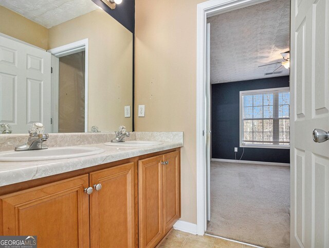 1301 Crosswind Pl, Mcdonough, GA 30252 - bathroom with double vanity, a textured ceiling, and a sink