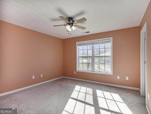 1301 Crosswind Pl, Mcdonough, GA 30252 - unfurnished room with baseboards, light carpet, a textured ceiling, visible vents, and ceiling fan