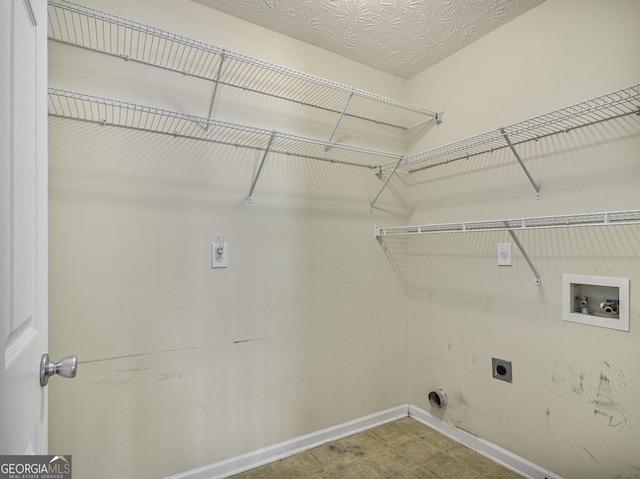 1301 Crosswind Pl, Mcdonough, GA 30252 - laundry room featuring laundry area, a textured ceiling, hookup for an electric dryer, washer hookup, and baseboards