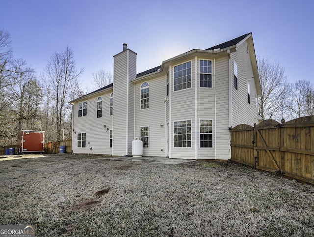 1301 Crosswind Pl, Mcdonough, GA 30252 - rear view of house featuring a patio, a chimney, fence, and a gate