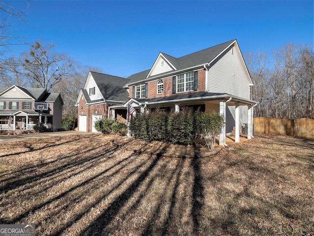 1301 Crosswind Pl, Mcdonough, GA 30252 - view of property exterior featuring concrete driveway, brick siding, fence, and an attached garage