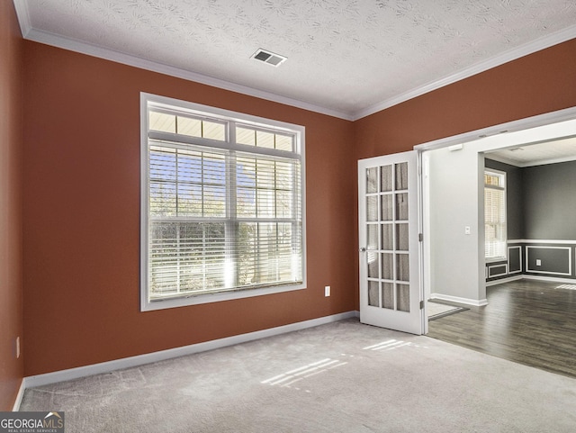 1301 Crosswind Pl, Mcdonough, GA 30252 - carpeted spare room featuring crown molding, baseboards, visible vents, and a textured ceiling