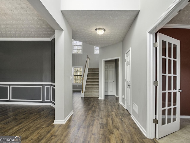1301 Crosswind Pl, Mcdonough, GA 30252 - foyer featuring stairway, a textured ceiling, a wainscoted wall, visible vents, and wood finished floors