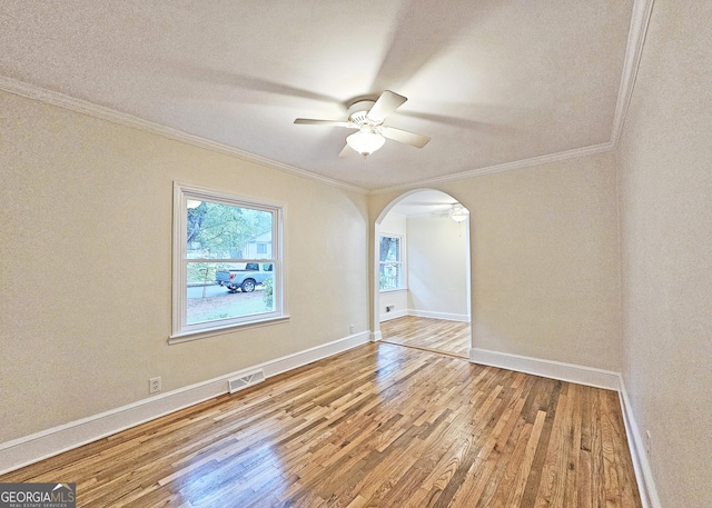 unfurnished room with wood-type flooring, ornamental molding, and ceiling fan