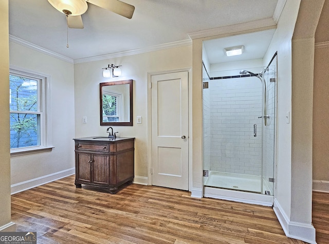 bathroom featuring hardwood / wood-style flooring, a shower with door, and ornamental molding