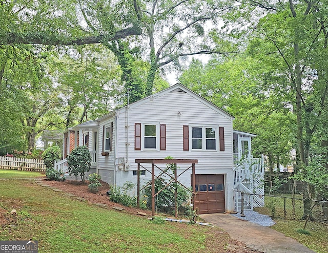 view of front of property with a garage and a front lawn