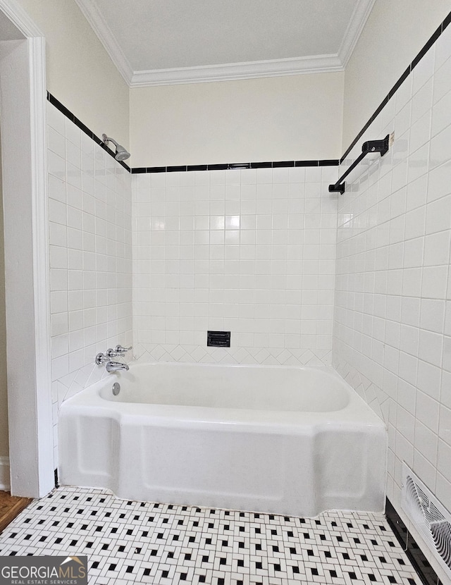 bathroom featuring tiled shower / bath combo, ornamental molding, and tile patterned floors