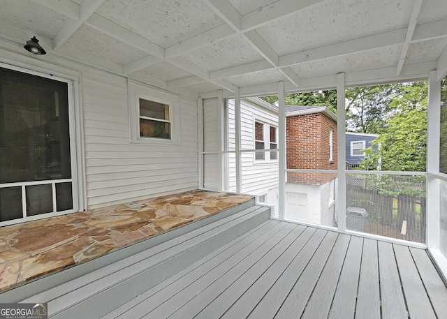 unfurnished sunroom featuring coffered ceiling