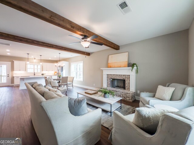 living room with beamed ceiling, dark hardwood / wood-style floors, and ceiling fan