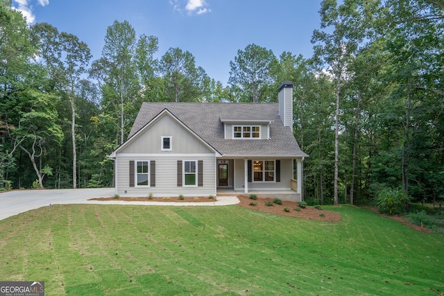 view of front of house with covered porch and a front yard