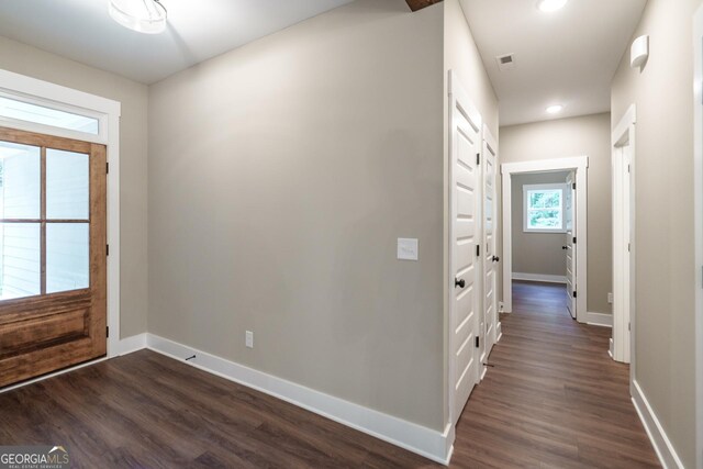 kitchen featuring a kitchen island, dark wood-type flooring, white cabinets, and decorative light fixtures