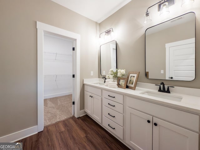 bathroom with vanity and wood-type flooring