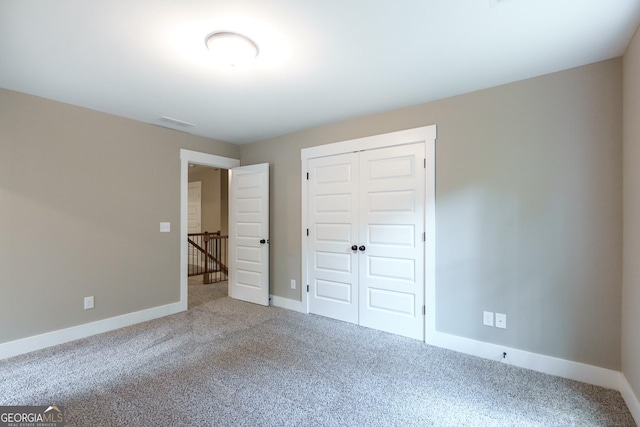 unfurnished bedroom featuring a closet and carpet