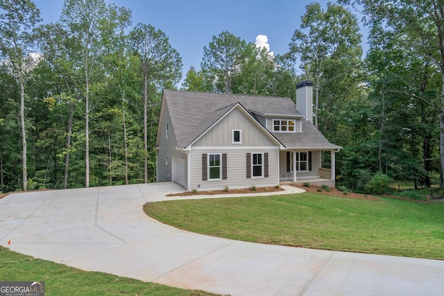 view of front of home with a garage, a front lawn, and a porch