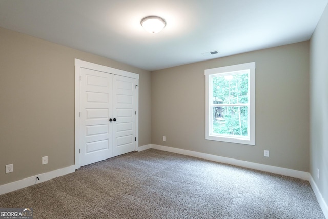 unfurnished bedroom featuring a closet and carpet