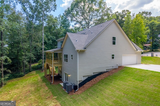 view of home's exterior featuring a garage, a lawn, and central air condition unit