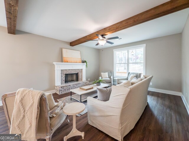 dining area featuring a brick fireplace, dark hardwood / wood-style floors, ceiling fan with notable chandelier, and beam ceiling