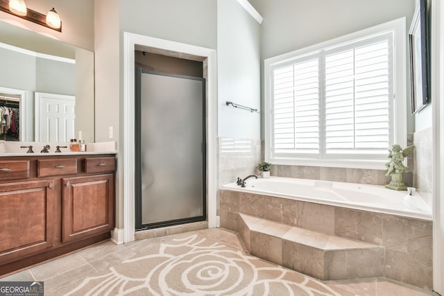 bathroom featuring vanity, crown molding, tile patterned flooring, and plus walk in shower