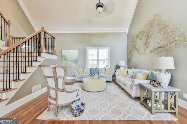 living room with ceiling fan, hardwood / wood-style floors, and ornamental molding