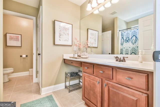 bathroom featuring tile patterned floors, vanity, and toilet