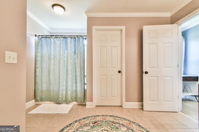 bathroom with tile patterned floors and ornamental molding