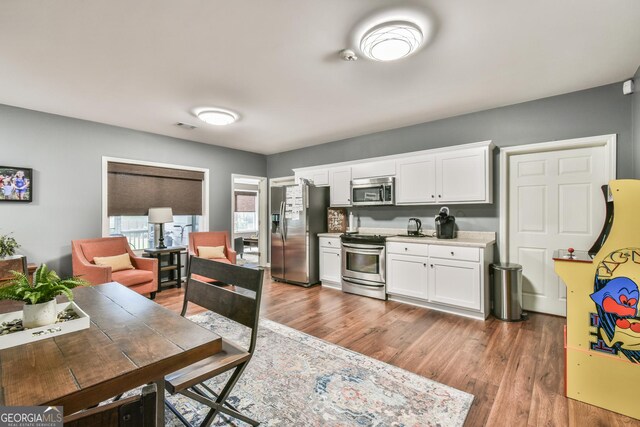 kitchen featuring white cabinetry, dark hardwood / wood-style flooring, and stainless steel appliances