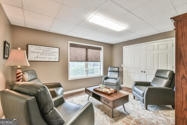 living room featuring a drop ceiling