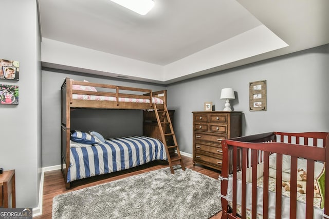 bedroom with dark wood-type flooring