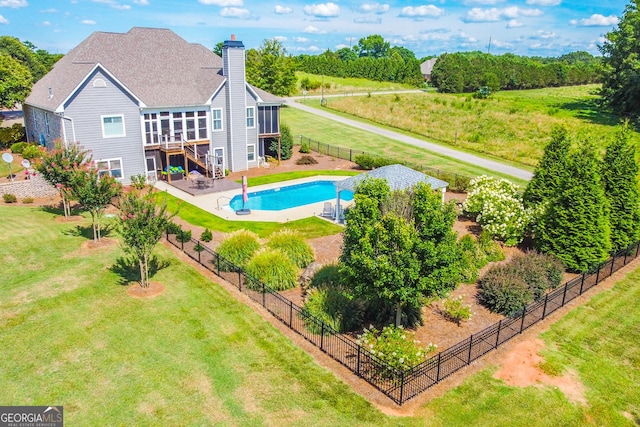 view of swimming pool featuring a lawn, a patio, and a deck