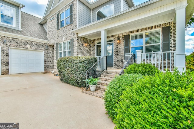 property entrance with a porch and a garage