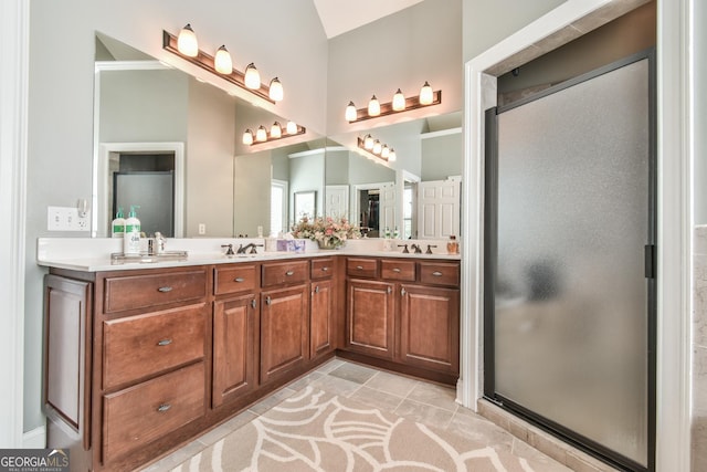 bathroom with vanity and a shower with door