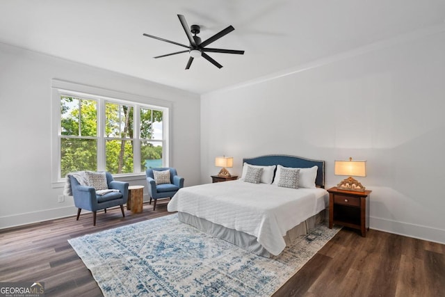 bedroom featuring ceiling fan, ornamental molding, and dark hardwood / wood-style floors