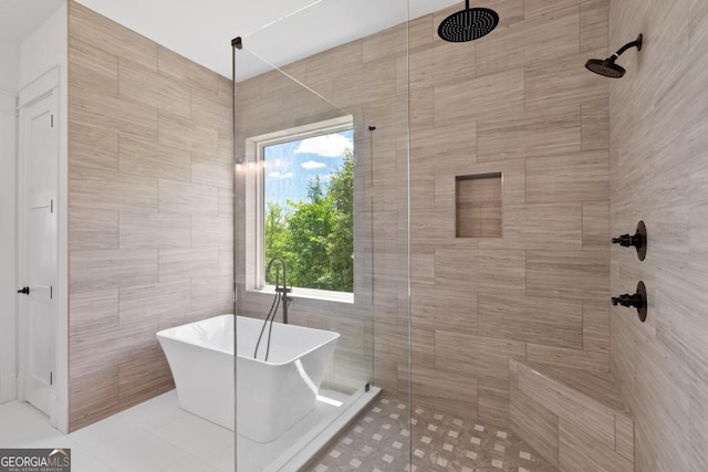 bathroom with independent shower and bath and a wealth of natural light