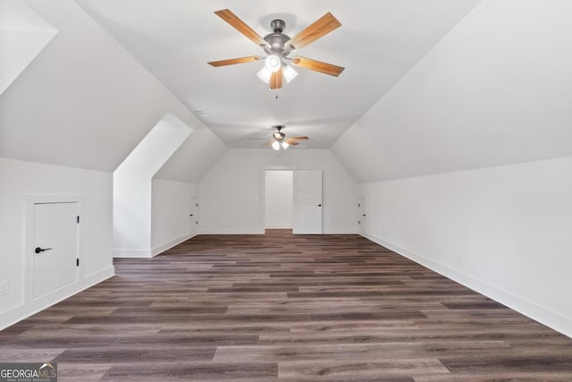 additional living space with vaulted ceiling, ceiling fan, and dark hardwood / wood-style flooring