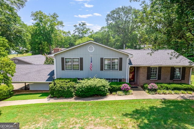 tri-level home with a front lawn