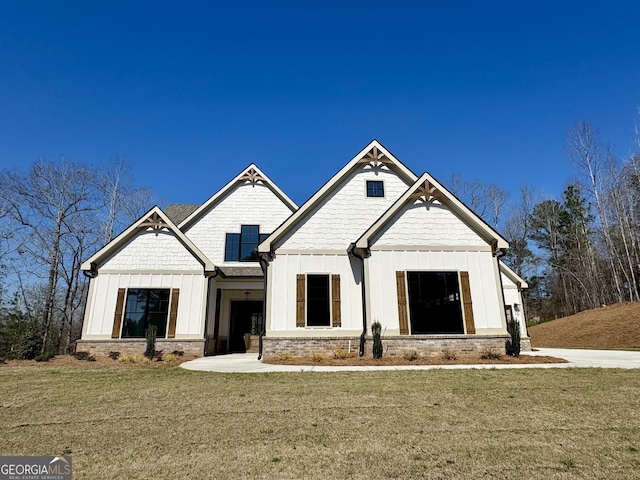 modern farmhouse style home featuring board and batten siding and a front lawn