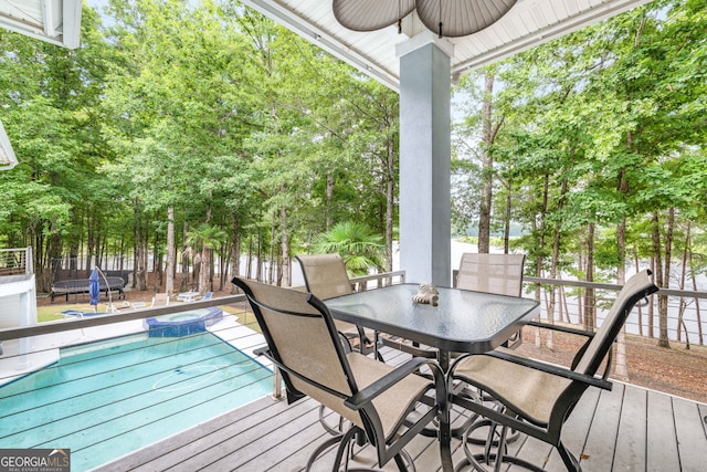 wooden terrace featuring a fenced in pool and ceiling fan